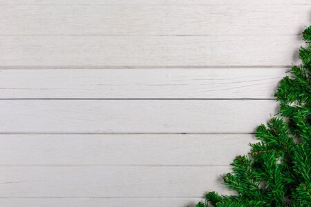 Fir branches on white wooden board. Christmas or New year backgroundの写真素材