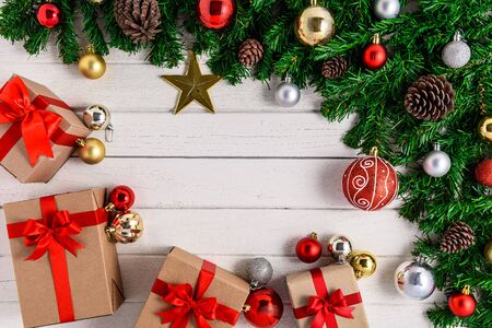 Christmas fir tree with decoration on white wooden board. Top view with copy spaceの写真素材