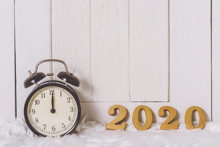 2020 wooden text on white fur and white wooden background. New year concept and copy space