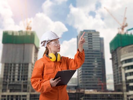 Portrait of Female Construction foreman supervisor or worker with Protection Equipment and blurred background is construction siteの写真素材