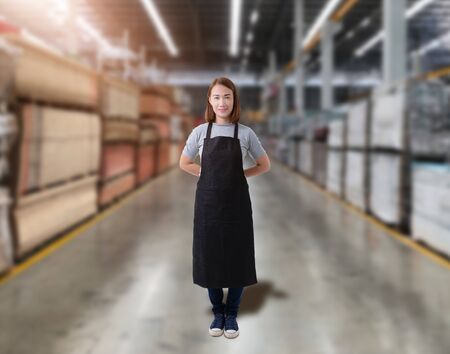 Portrait of Female staff warehouse operator with Blurred the background of Construction material on product shelf in storeの写真素材