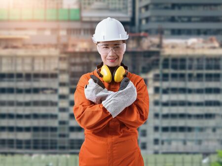 Portrait of Female Construction foreman supervisor or worker with Protection Equipment and blurred background is construction siteの写真素材