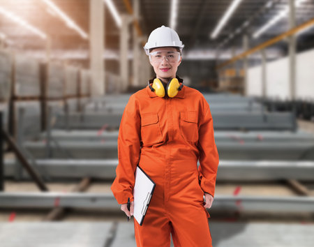 Portrait of Female staff warehouse operator with Blurred the background of Construction material on...