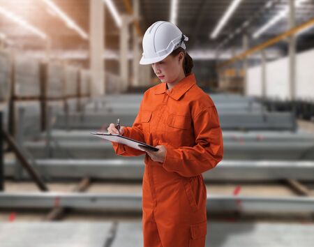 Portrait of Female staff warehouse operator with Blurred the background of Construction material on product shelf in storeの写真素材