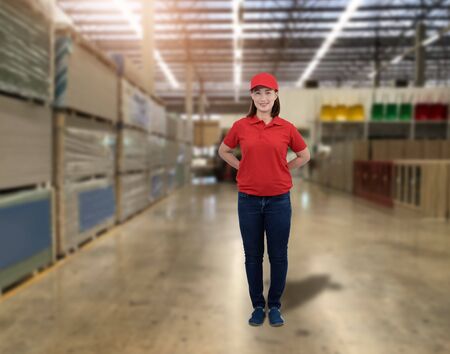Portrait of Female staff warehouse operator with Blurred the background of Construction material on product shelf in storeの写真素材