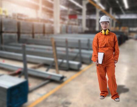 Portrait of Female staff warehouse operator with Blurred the background of Construction material on product shelf in storeの写真素材