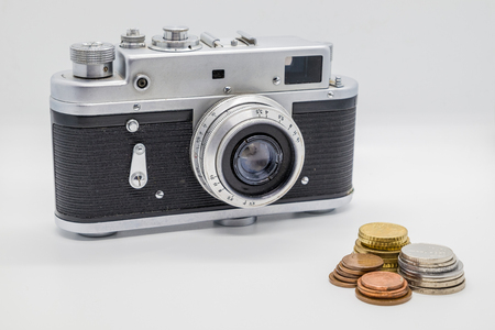 Vintage film camera are taking coins moneyの写真素材
