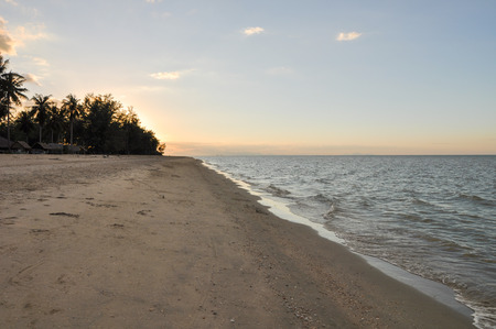 Dirty brown sand beach on sunset timeの写真素材