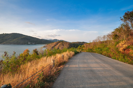 Road on hill ahead to the ocean, Two side had tropical deciduous forest, Phuket Thailandの写真素材