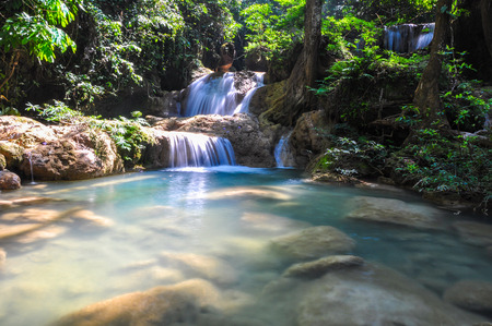 The soft stream is flowing through the rocks in tropical rain forestの写真素材