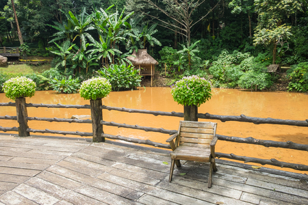 Wooden chair on the rear porch with lake and forest.の写真素材