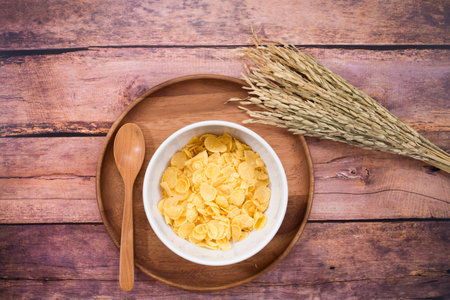 Top of view of cup of milk, black coffee  left side corn flakes, Dark wooden background, Right side...