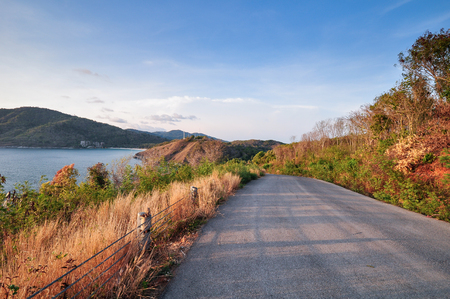 Road on hill ahead to the ocean, Two side had tropical deciduous forest, Phuket Thailandの写真素材