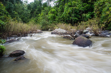 A waterfall`s origin from a hill top with a forestの写真素材
