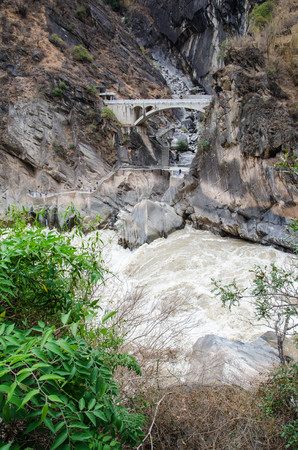Horizontal outdoors shot of big river streaming in Shangri-La , China,Rock bridgeの写真素材