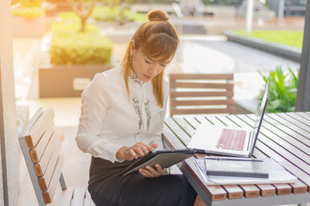 Asian woman using tablet and laptopの写真素材