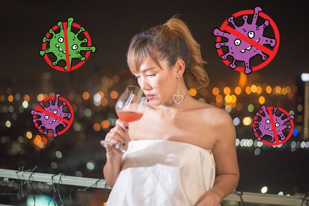 lonely asian woman with red cocktail in white dress, background is night city have bokehの写真素材