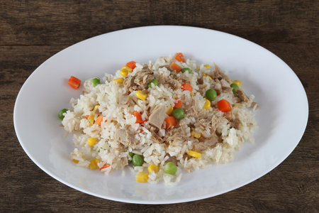 Fried rice with tuna and vegetables on wooden background close upの写真素材