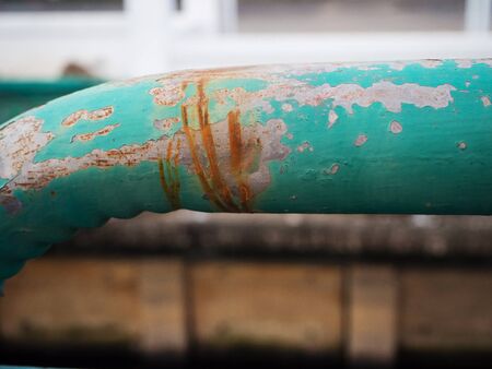 rusty on green pipeの写真素材