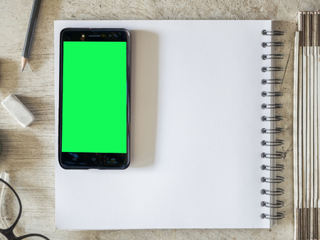 Smartphone mobile on paper notebookの写真素材