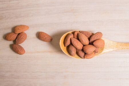 Almond nut on wood table imageの写真素材