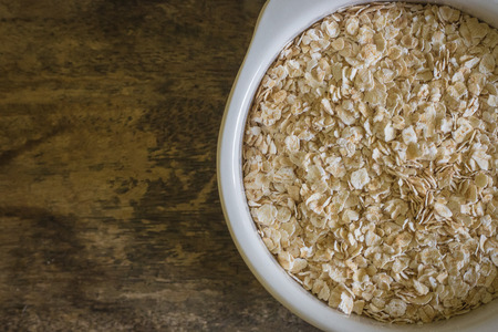 The oats rice in white bowl on top table wood worm tone imageの写真素材