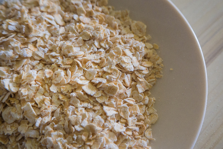 The oats rice in white bowl on top table wood worm tone imageの写真素材