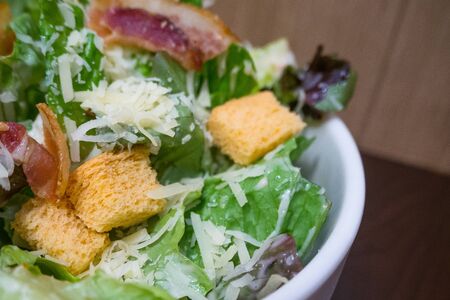 The Caesar salad in white bowl image close up.の写真素材