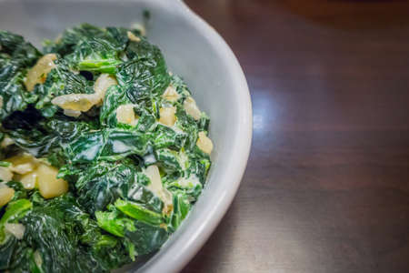 The spinach with garlic butter in white bowl close up image.の写真素材