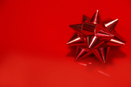 The Shiny red satin ribbon on red background.の写真素材