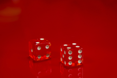 The Two Red dice on bright red glossy background.の写真素材