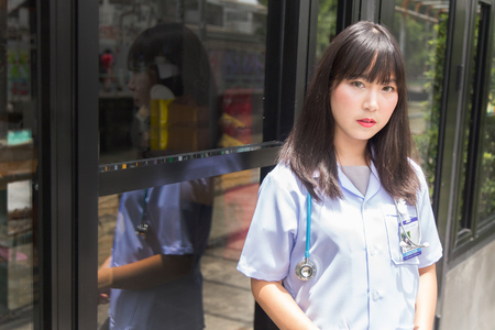 The woman Asian doctorÂ  White Shirt suit with stethoscope outdoor Hospital.の写真素材