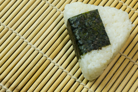 Japanese food Onigiri  white rice formed into triangular or cylindrical shapes and often wrapped in nori.の写真素材