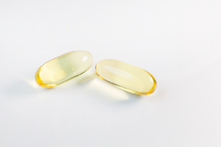 fish oil capsule close up image on white background.の写真素材