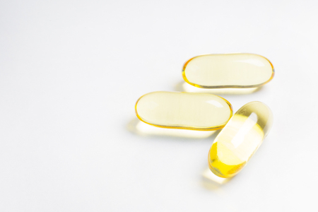 fish oil capsule close up image on white background.の写真素材