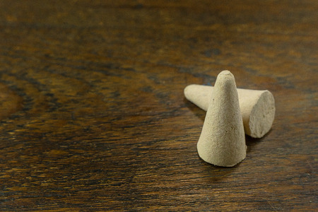 The Incense Cone in a stand with the feather for background.の写真素材