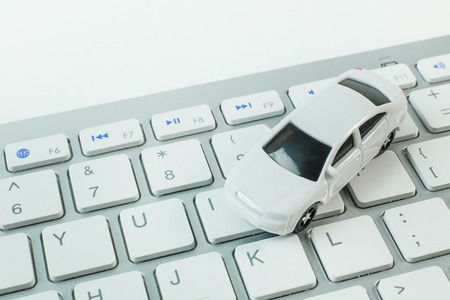 white toy car on keyboard computer close up image background.の写真素材