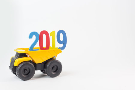 Yellow truck hold 2019 number on white background.の写真素材