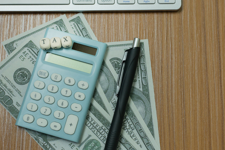 The tax wooden cubic on work table for business content.の写真素材