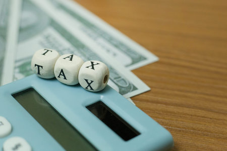 The tax wooden cubic on work table for business content.