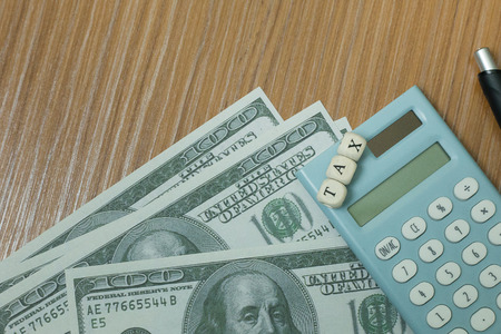 The tax wooden cubic on work table for business content.の写真素材