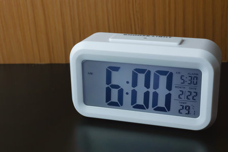 The digital alarm clock  6:00 close up image.