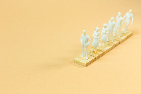 The  white  figure miniature on orange pastel for business content.の写真素材