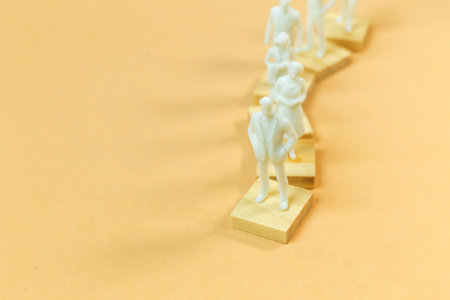 The  white  figure miniature on orange pastel for business content.