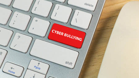 The cyber bullying red button on silver keyboard .