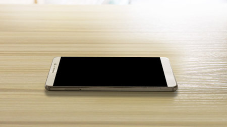 The image smart phone on white wood table.
