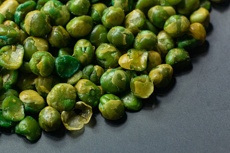The salted peas on black Ceramic Plate close up image.