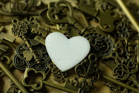 The white heart and gold key  for valentines day content.の写真素材