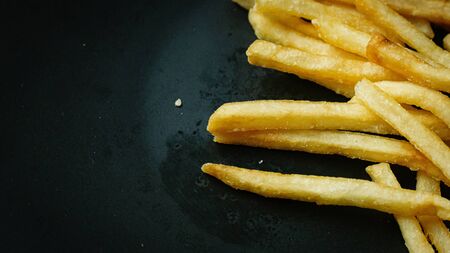The French fries on black plate for food content.の写真素材