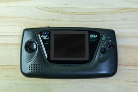 BANGKOK, THAILAND  6 SEP, 2020 : Game Gear on wooden table.のeditorial素材